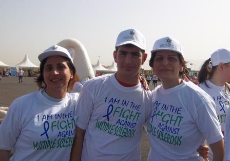 Two women and a man wearing T-shirts and hats saying 'I am in the fight against MS'