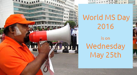 a man with a megaphone speaks to a group of people